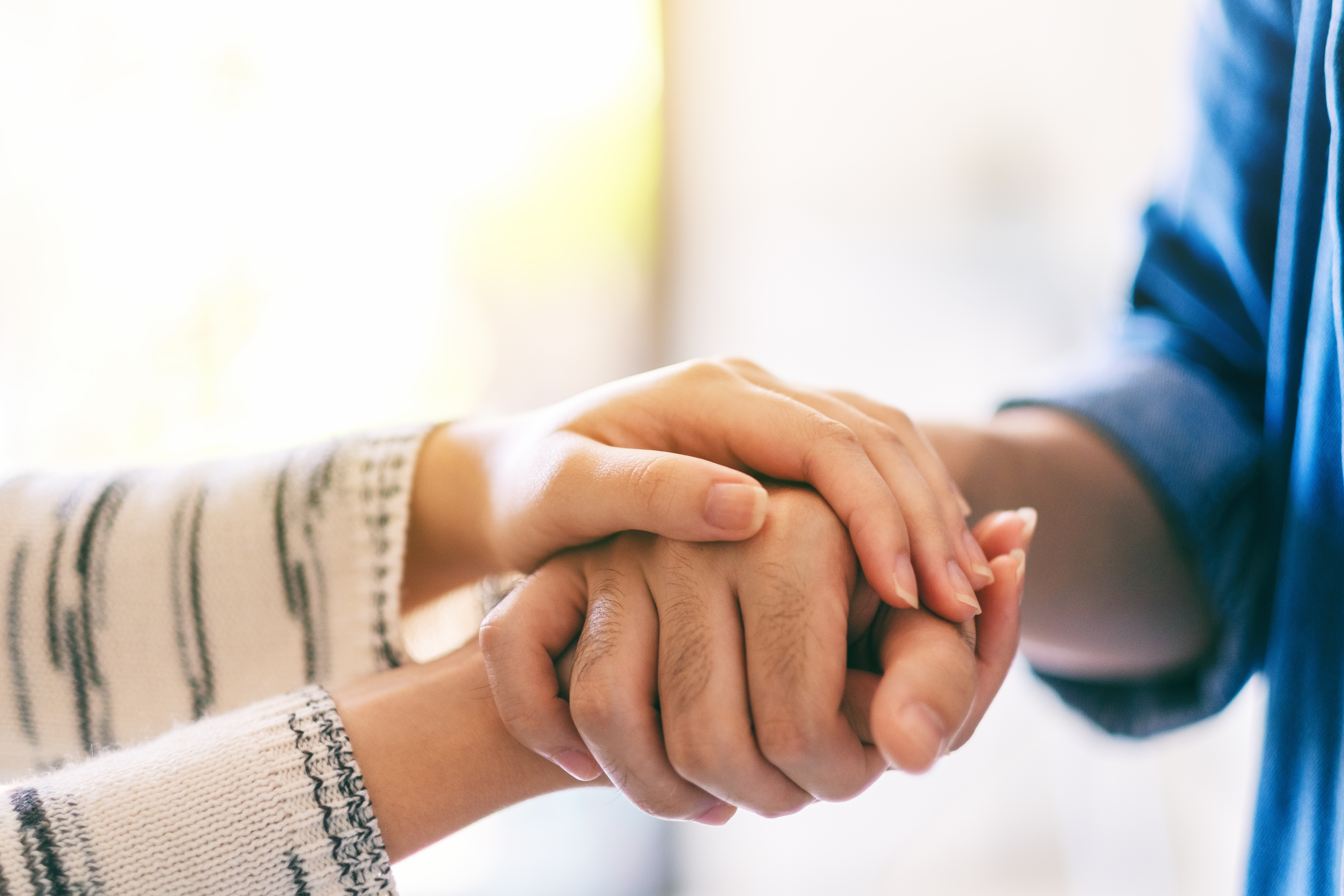 close up holding hands